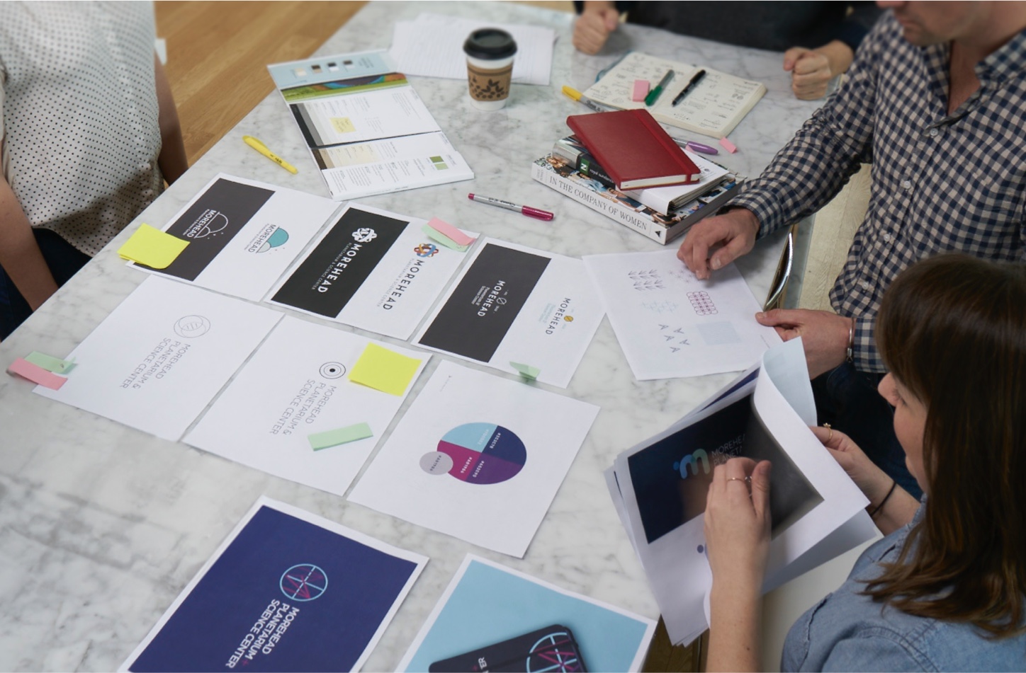 Rivers staff reviewing branding items